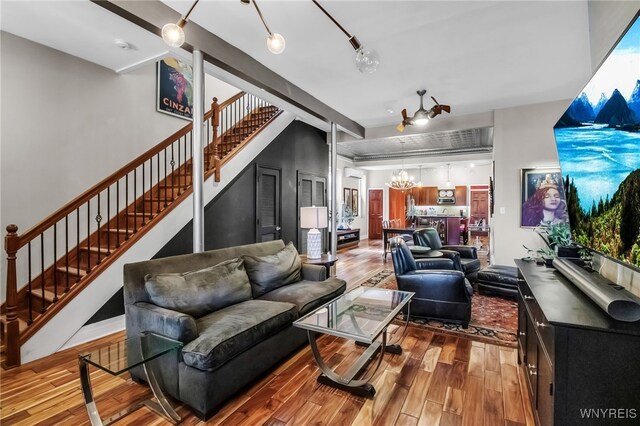 509 Virginia St, Buffalo, NY 14202 - living room with stairs, wood finished floors, and a chandelier