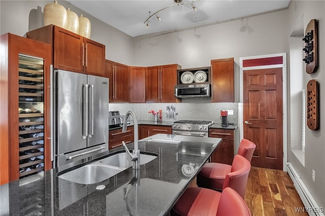 509 Virginia St, Buffalo, NY 14202 - kitchen featuring premium appliances, a baseboard heating unit, a sink, backsplash, and wood finished floors