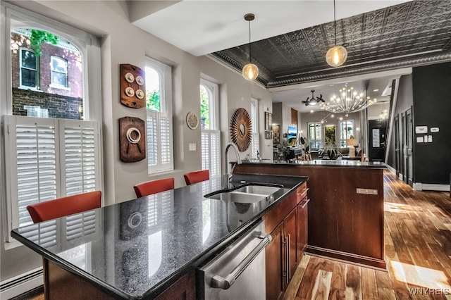 509 Virginia St, Buffalo, NY 14202 - kitchen with a sink, stainless steel dishwasher, wood-type flooring, a baseboard heating unit, and a chandelier