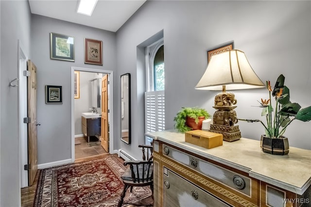 509 Virginia St, Buffalo, NY 14202 - hall with baseboard heating, baseboards, and wood finished floors
