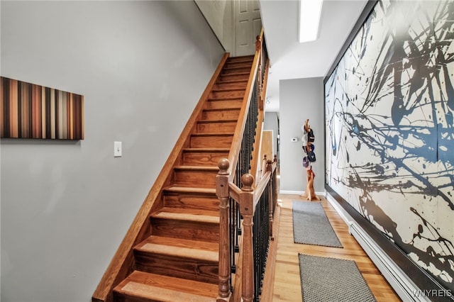 509 Virginia St, Buffalo, NY 14202 - stairway featuring baseboard heating, wood finished floors, and baseboards
