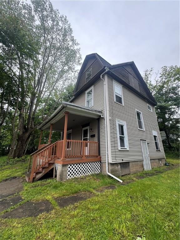 213 Flint St, Rochester, NY 14608 - back of property with covered porch and a yard