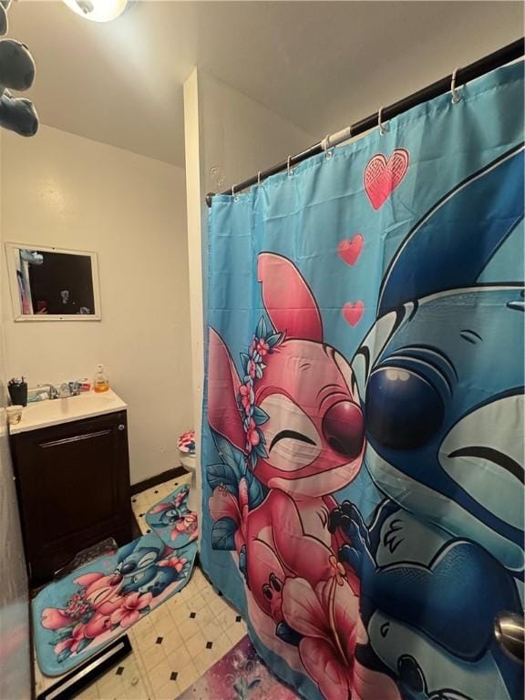 213 Flint St, Rochester, NY 14608 - bathroom with tile patterned floors, vanity, toilet, and curtained shower