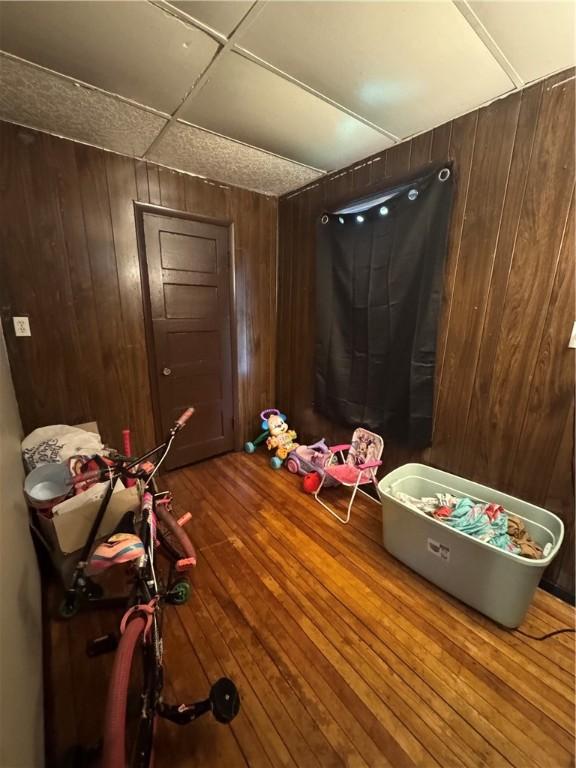 213 Flint St, Rochester, NY 14608 - interior space with wood walls and wood finished floors