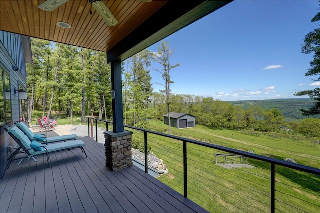 8763 Greyton H Taylor Memorial Dr, Urbana, NY 14840 - wooden terrace with an outdoor structure, a lawn, a forest view, and a ceiling fan