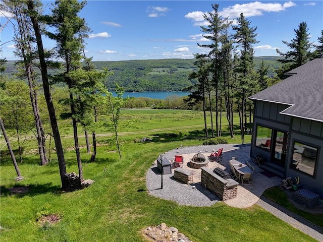 8763 Greyton H Taylor Memorial Dr, Urbana, NY 14840 - view of grassy yard with a fire pit, a patio, a water view, and a wooded view