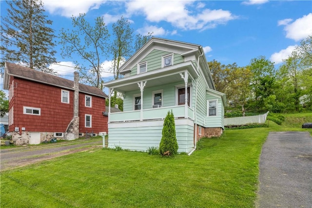 3 Maple St, Lyons, NY 14489 - view of front facade with a front yard and a porch
