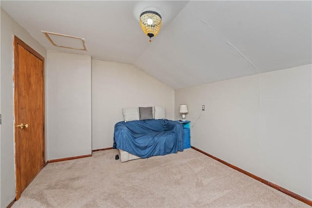 3 Maple St, Lyons, NY 14489 - unfurnished bedroom with attic access, carpet flooring, vaulted ceiling, and baseboards