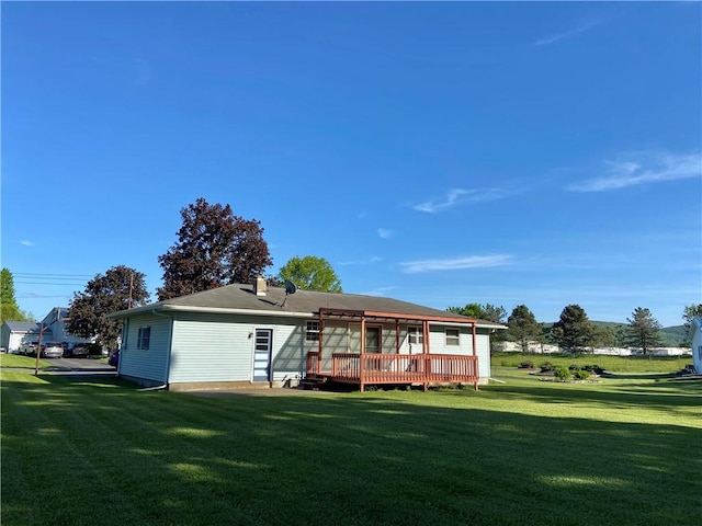 5 Melvins Ln, Big Flats, NY 14845 - rear view of house featuring a wooden deck and a lawn