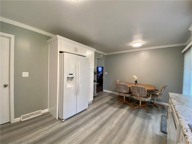 5 Melvins Ln, Big Flats, NY 14845 - kitchen with white refrigerator with ice dispenser, light wood finished floors, baseboards, ornamental molding, and white cabinetry