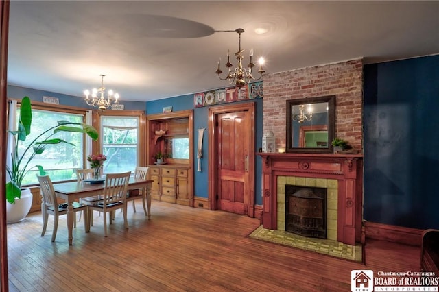 25 Academy St, Westfield, NY 14787 - dining space with a chandelier, hardwood / wood-style flooring, and a tiled fireplace