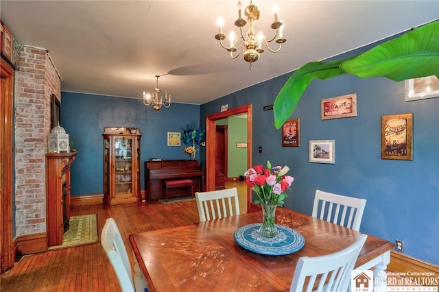 25 Academy St, Westfield, NY 14787 - dining space with a chandelier, hardwood / wood-style flooring, baseboards, and a fireplace