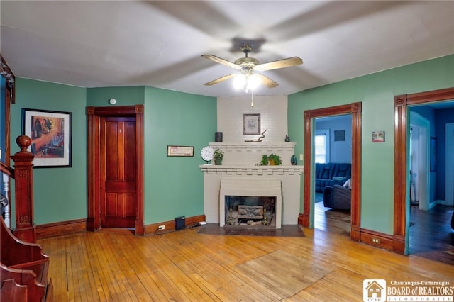 25 Academy St, Westfield, NY 14787 - living area with baseboards, a fireplace, a ceiling fan, and wood-type flooring