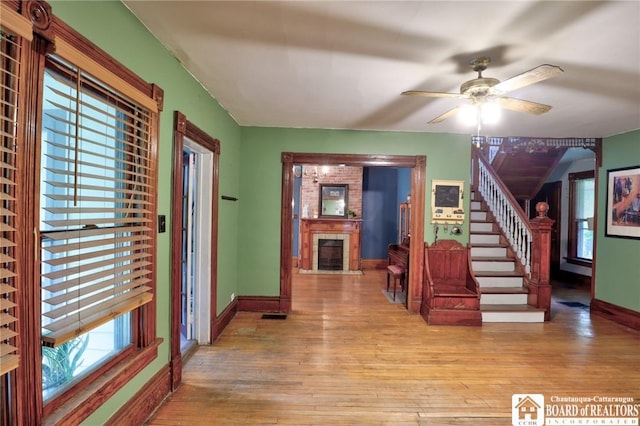 25 Academy St, Westfield, NY 14787 - entryway with wood-type flooring, a fireplace, baseboards, and ceiling fan