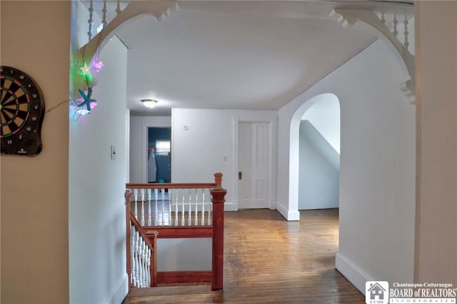 25 Academy St, Westfield, NY 14787 - corridor with arched walkways, wood finished floors, baseboards, and an upstairs landing