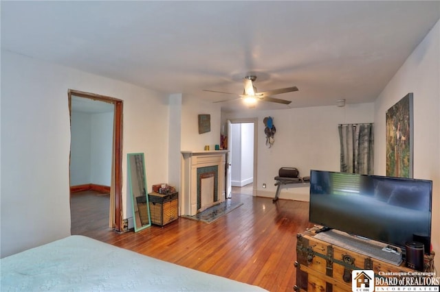 25 Academy St, Westfield, NY 14787 - bedroom with hardwood / wood-style flooring, a fireplace, baseboards, and a ceiling fan