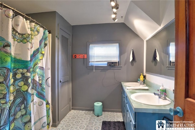 25 Academy St, Westfield, NY 14787 - full bath with rail lighting, double vanity, baseboards, and a shower with curtain