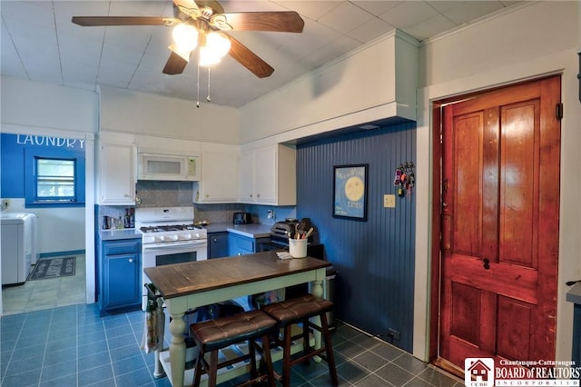 25 Academy St, Westfield, NY 14787 - kitchen featuring white appliances, washing machine and clothes dryer, white cabinets, and dark tile patterned flooring