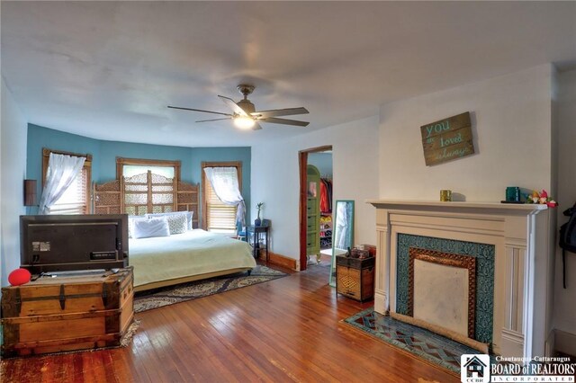 25 Academy St, Westfield, NY 14787 - bedroom featuring wood finished floors, baseboards, a fireplace with flush hearth, and ceiling fan