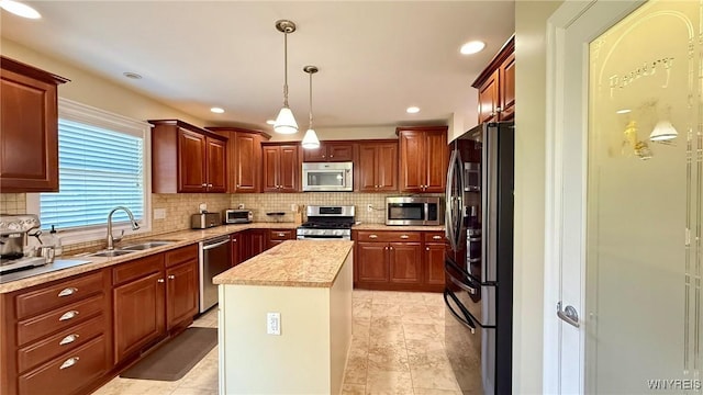65 Islewoods, Grand Island, NY 14072 - kitchen featuring appliances with stainless steel finishes, a sink, a center island, decorative backsplash, and hanging light fixtures