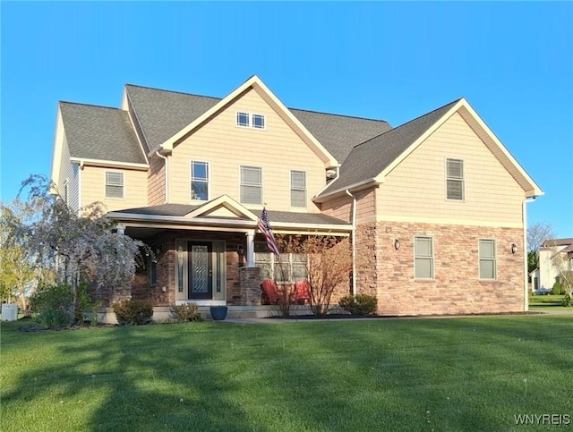 65 Islewoods, Grand Island, NY 14072 - view of front facade featuring a front yard, covered porch, and roof with shingles