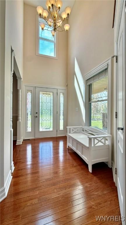 65 Islewoods, Grand Island, NY 14072 - entryway featuring a towering ceiling, hardwood / wood-style flooring, and a chandelier