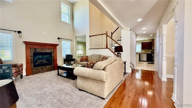 65 Islewoods, Grand Island, NY 14072 - living area with plenty of natural light, stairway, a fireplace, wood-type flooring, and recessed lighting