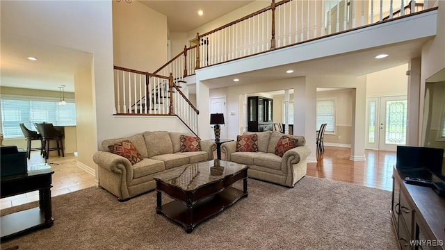 65 Islewoods, Grand Island, NY 14072 - carpeted living area with a high ceiling, stairway, recessed lighting, and baseboards