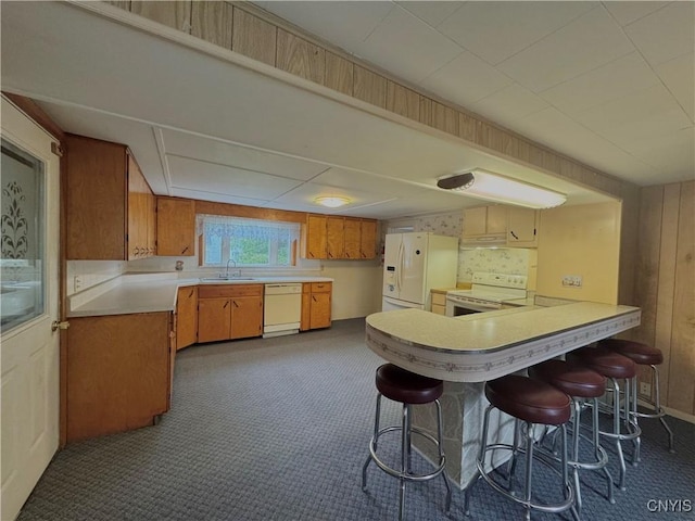 411 Hamilton St, Rome-Inside, NY 13440 - kitchen featuring white appliances, a sink, light countertops, a peninsula, and brown cabinetry