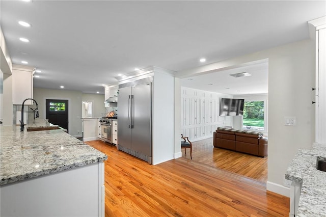 1 Creekside Ln, Pittsford, NY 14618 - kitchen with high end appliances, light wood-style floors, plenty of natural light, and recessed lighting