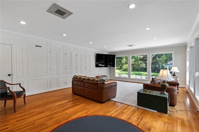 1 Creekside Ln, Pittsford, NY 14618 - living room featuring light wood-type flooring, crown molding, a decorative wall, and recessed lighting