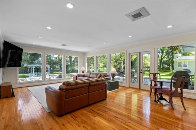 1 Creekside Ln, Pittsford, NY 14618 - living room featuring ornamental molding, french doors, plenty of natural light, light wood finished floors, and recessed lighting