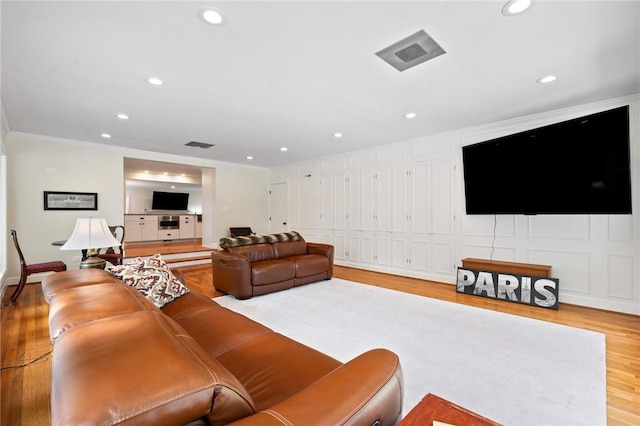 1 Creekside Ln, Pittsford, NY 14618 - living room with wood finished floors, ornamental molding, and recessed lighting