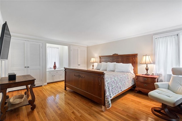 1 Creekside Ln, Pittsford, NY 14618 - bedroom with light wood-type flooring, crown molding, and multiple closets