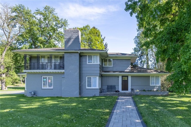 1 Creekside Ln, Pittsford, NY 14618 - view of front of house with a chimney, a front lawn, and brick siding