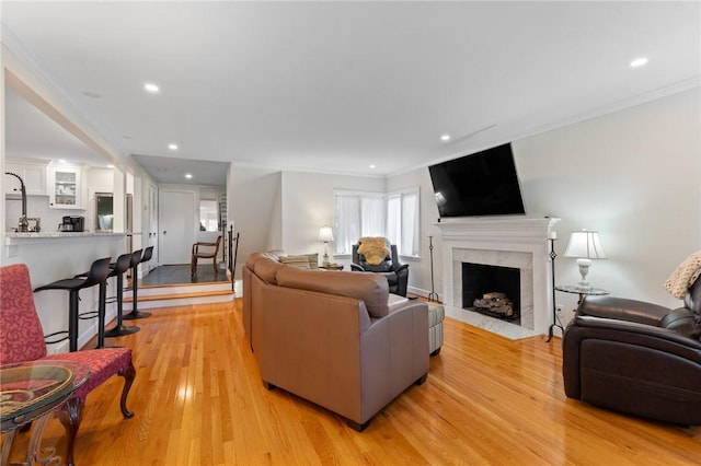 1 Creekside Ln, Pittsford, NY 14618 - living area with a high end fireplace, light wood-type flooring, crown molding, and recessed lighting