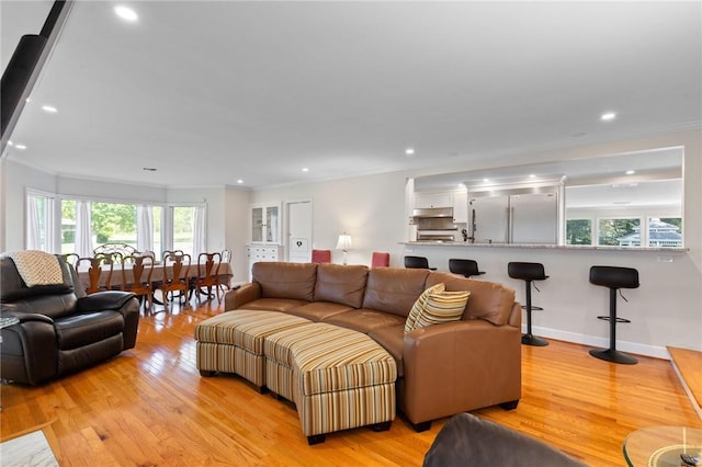 1 Creekside Ln, Pittsford, NY 14618 - living area featuring healthy amount of natural light, ornamental molding, light wood-type flooring, and recessed lighting