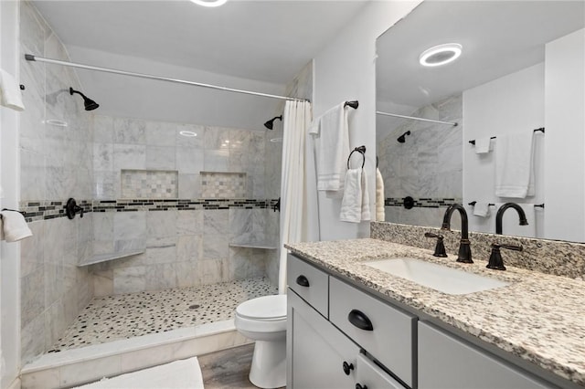 1 Creekside Ln, Pittsford, NY 14618 - bathroom with vanity, toilet, a tile shower, and wood finished floors