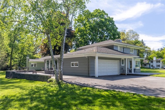1 Creekside Ln, Pittsford, NY 14618 - view of front of property featuring a garage, a front lawn, driveway, and a patio