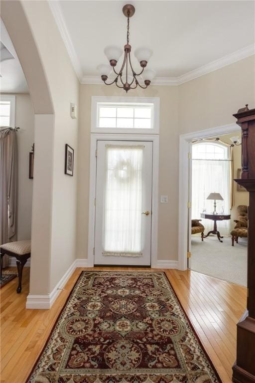 31 Hunters Run, Horseheads, NY 14845 - entrance foyer with arched walkways, a chandelier, light wood-type flooring, and crown molding