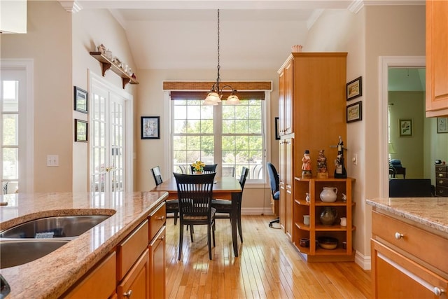 31 Hunters Run, Horseheads, NY 14845 - kitchen with light wood-style flooring, baseboards, hanging light fixtures, light stone countertops, and vaulted ceiling