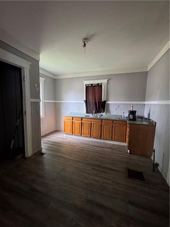 127 Maryland St, Rochester, NY 14613 - kitchen with a wainscoted wall, dark wood-style flooring, brown cabinets, and crown molding
