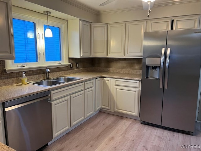 90 Nadon Pl, Tonawanda-Town, NY 14150 - kitchen with appliances with stainless steel finishes, a sink, decorative backsplash, light wood-style floors, and crown molding