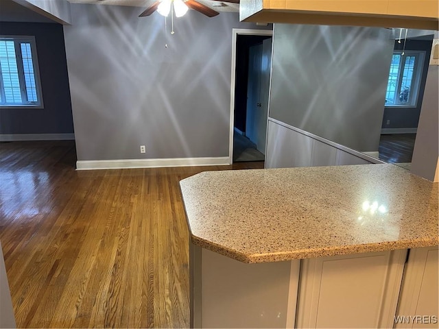 90 Nadon Pl, Tonawanda-Town, NY 14150 - kitchen featuring wood finished floors, baseboards, a ceiling fan, and light stone counters