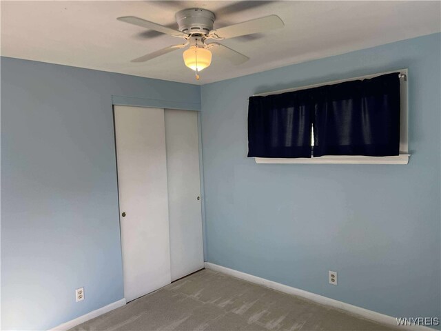 90 Nadon Pl, Tonawanda-Town, NY 14150 - unfurnished bedroom with a closet, carpet floors, baseboards, and a ceiling fan