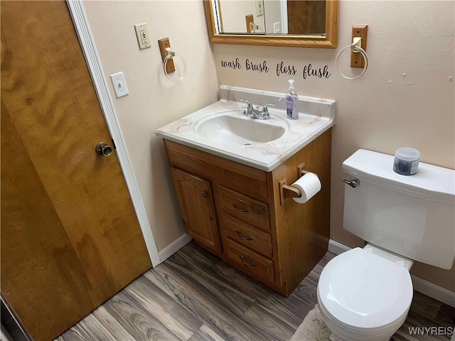 90 Nadon Pl, Tonawanda-Town, NY 14150 - half bathroom with vanity, toilet, wood finished floors, and baseboards