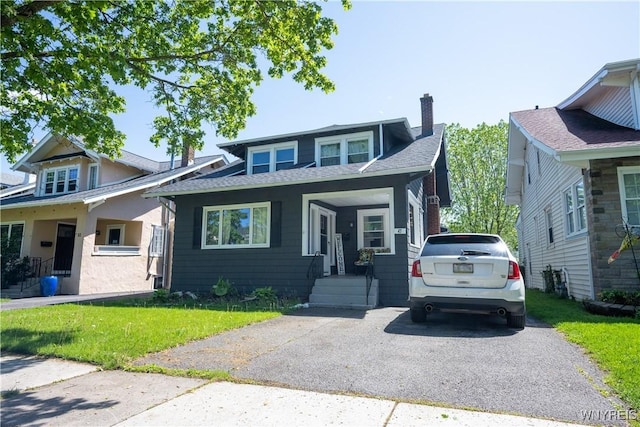 47 Winston Rd, Buffalo, NY 14216 - bungalow featuring a chimney, a front lawn, and roof with shingles