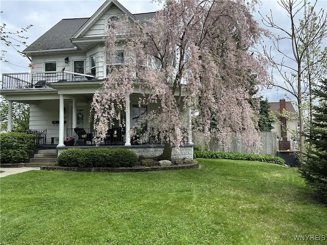 938 Ridge Rd, Lackawanna, NY 14218 - victorian-style house with a balcony, a front lawn, covered porch, and roof with shingles