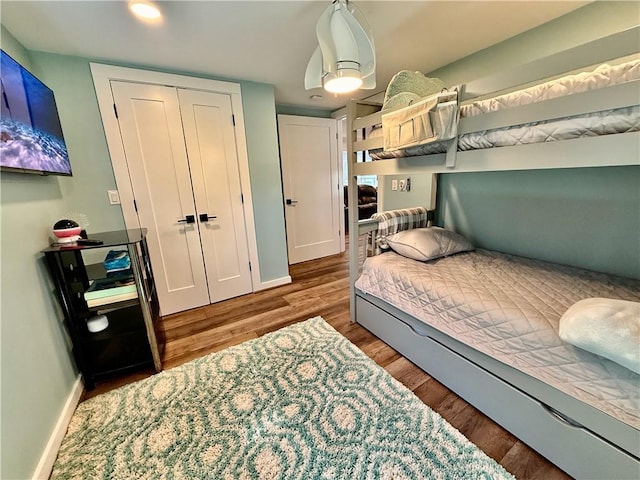 8119 Martin Rd, Wolcott, NY 14590 - bedroom with baseboards, wood finished floors, a closet, and recessed lighting