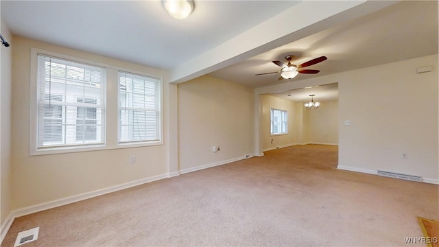 524 Lasalle Ave, Buffalo, NY 14215 - unfurnished room with a chandelier, light colored carpet, ceiling fan, and baseboards